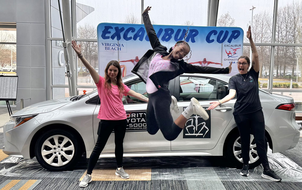Gymnasts jumping for joy 2026 Excalibur Cup car winners Coastal Gymnastics from Virginia